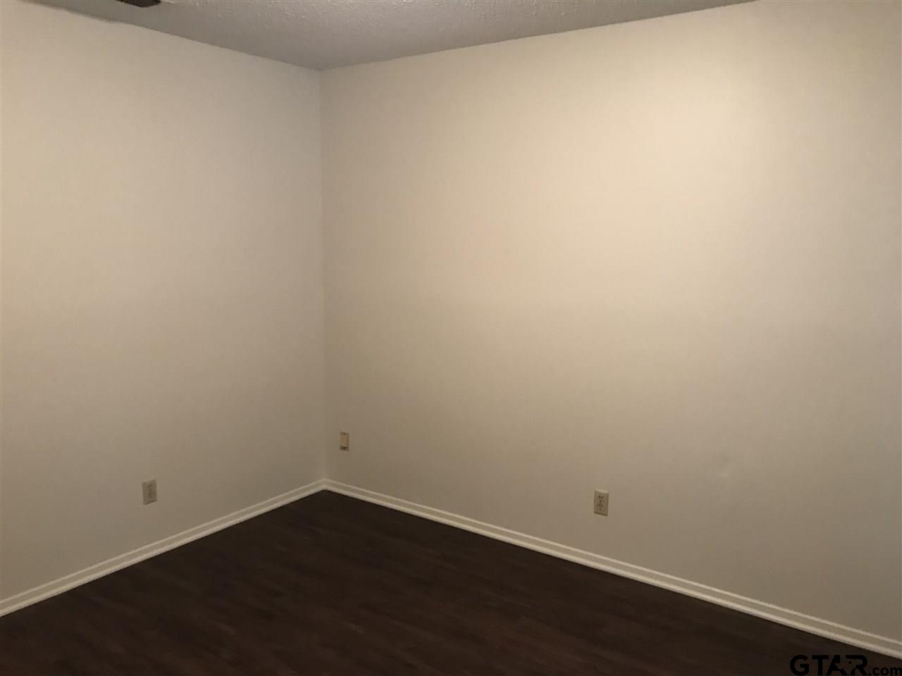 3721 Colony Park Drive Tyler, TX 75701 - Photo 6 of 11 an empty room with wooden floor and windows