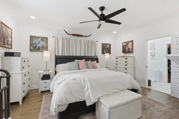 a spacious bedroom with a bed and ceiling fan