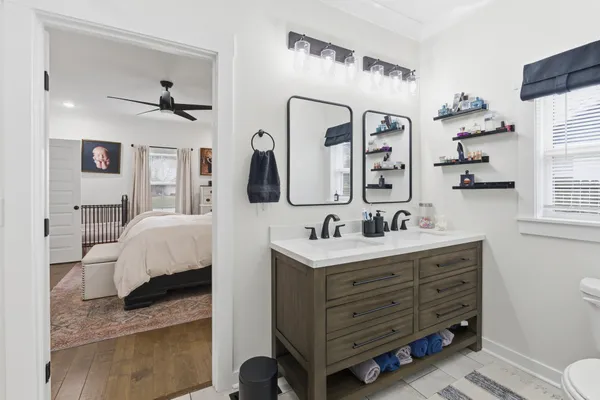 a en suite bathroom with a double vanity sink and a mirror
