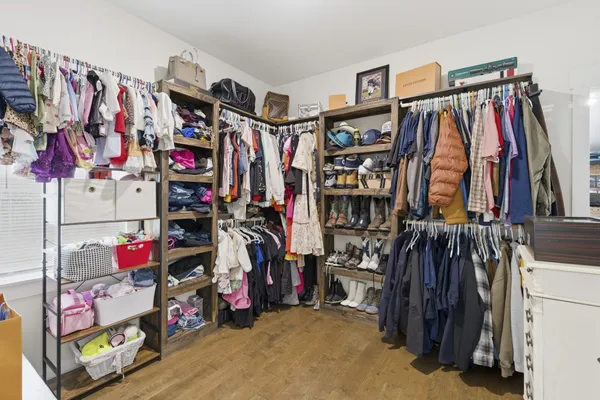 a view of walk in closet with clothes