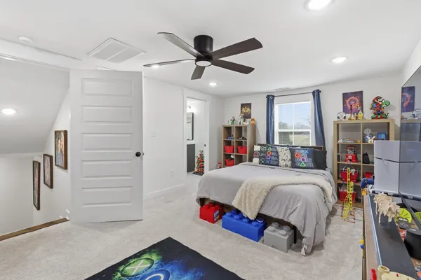 a bedroom with a bed and a book shelf