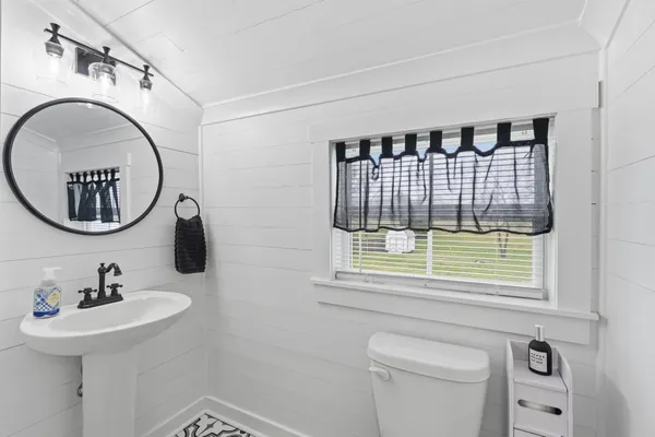 a bathroom with a sink a mirror and a toilet