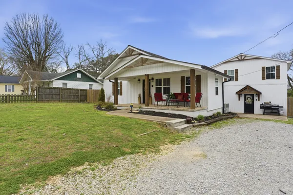 a view of a house with swimming pool and porch