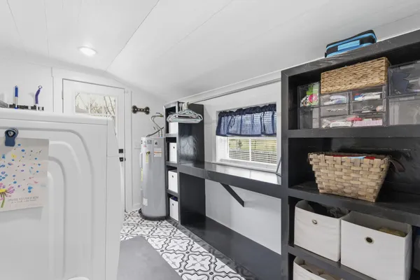 a kitchen with stainless steel appliances cabinets and window