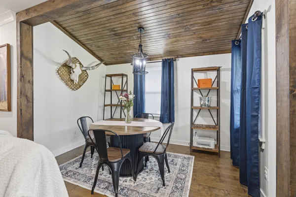 a dining room with a wooden table and chairs