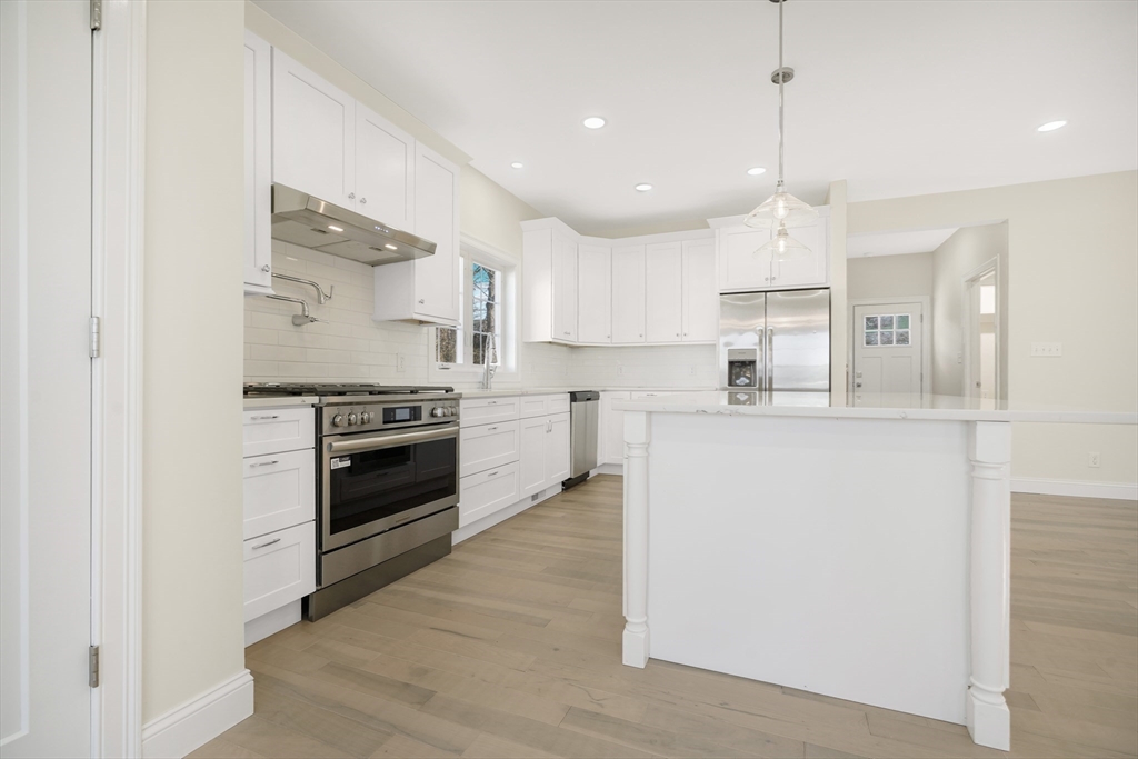 144 Bailey Street Fall River, MA 02724 - Photo 12 of 37 a kitchen with stainless steel appliances a stove a sink and a refrigerator