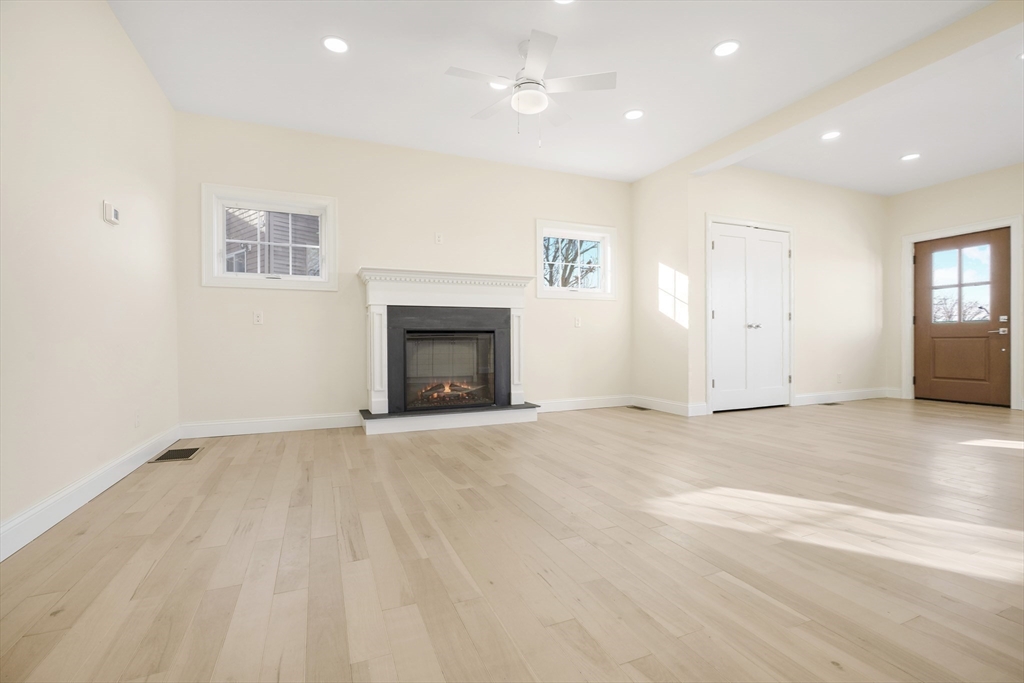 144 Bailey Street Fall River, MA 02724 - Photo 14 of 37 an empty room with windows and fireplace