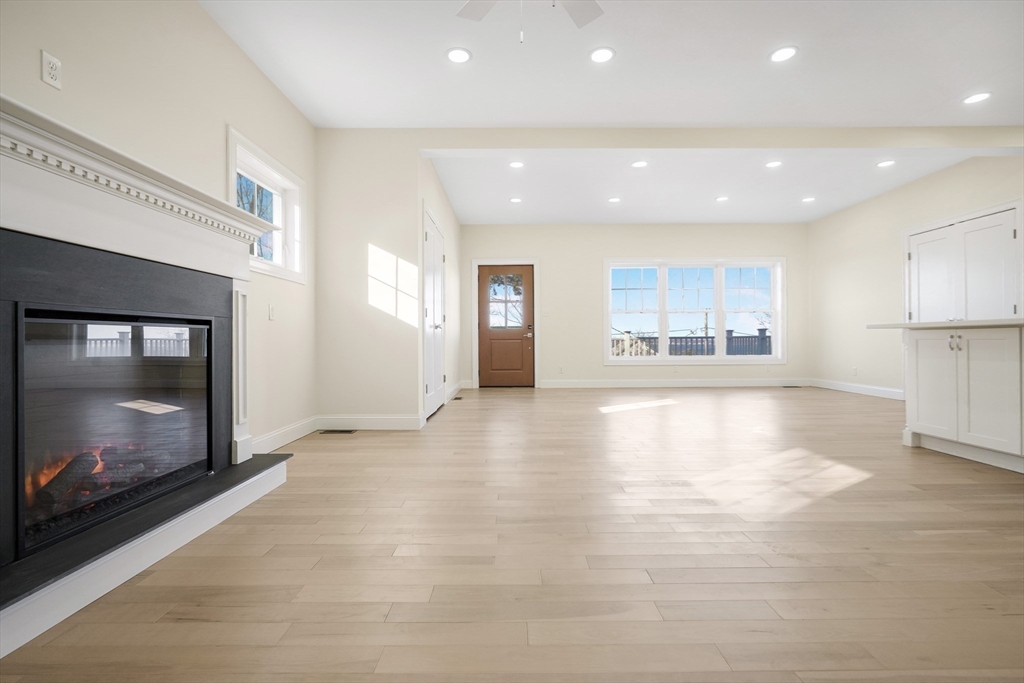 144 Bailey Street Fall River, MA 02724 - Photo 15 of 37 a view of empty room with kitchen and fireplace