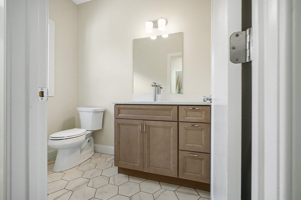 144 Bailey Street Fall River, MA 02724 - Photo 18 of 37 a bathroom with a toilet a sink and a mirror