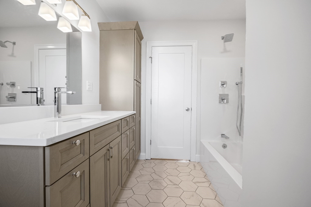 144 Bailey Street Fall River, MA 02724 - Photo 27 of 37 a bathroom with a granite countertop sink a mirror and a bathtub