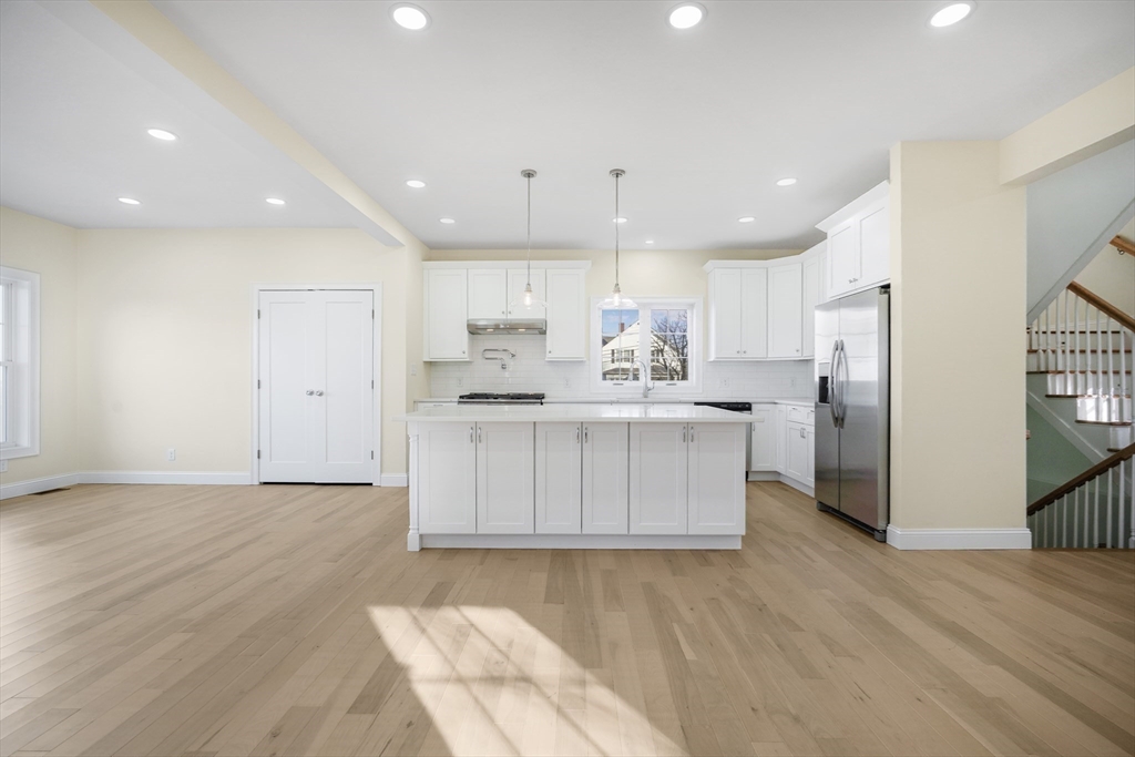 144 Bailey Street Fall River, MA 02724 - Photo 6 of 37 a kitchen with stainless steel appliances kitchen island hardwood floor sink and stove
