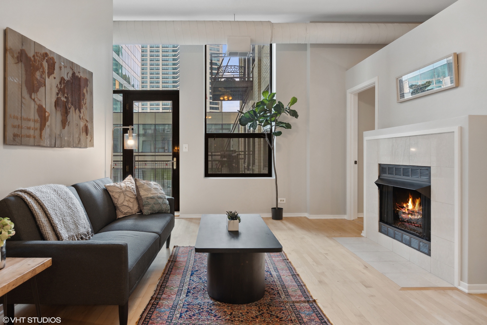 910 South Michigan Avenue, Unit 816 Chicago, IL 60605 - Photo 3 of 21 a living room with furniture and a fireplace