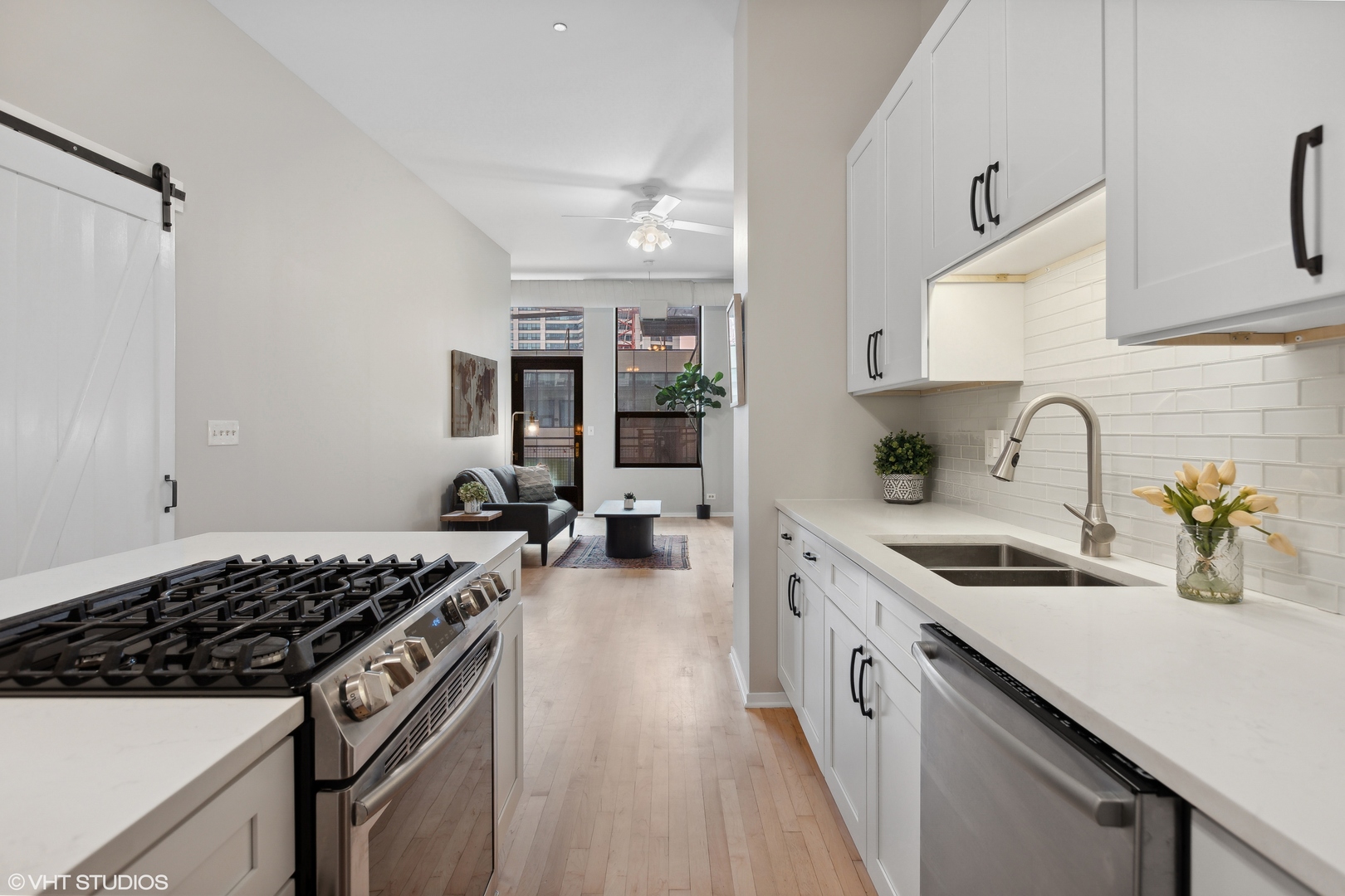 910 South Michigan Avenue, Unit 816 Chicago, IL 60605 - Photo 7 of 21 a kitchen with a sink a stove and cabinets