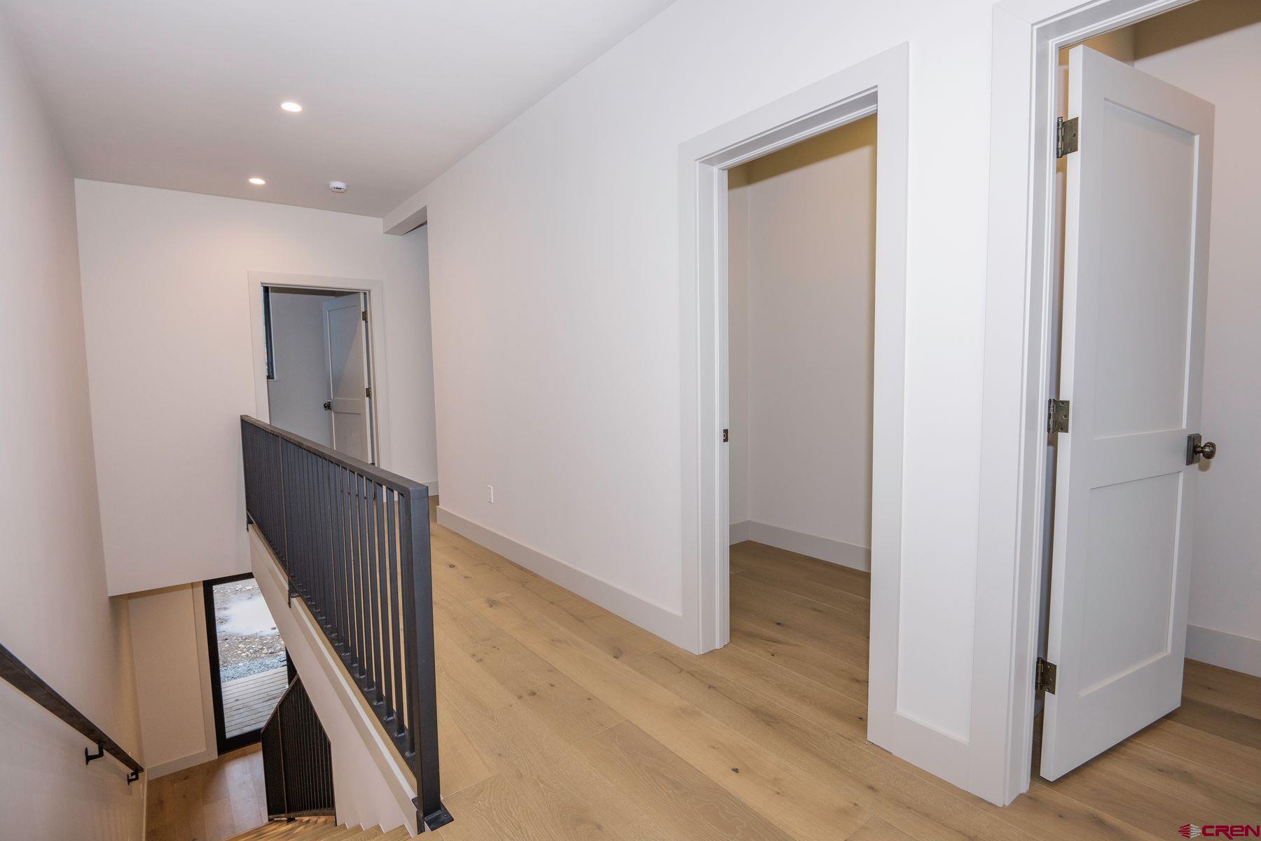 180 Elk Valley Road, Unit 107 Crested Butte, CO 81224 - Photo 11 of 35 a view of a hallway with wooden floor and stairs
