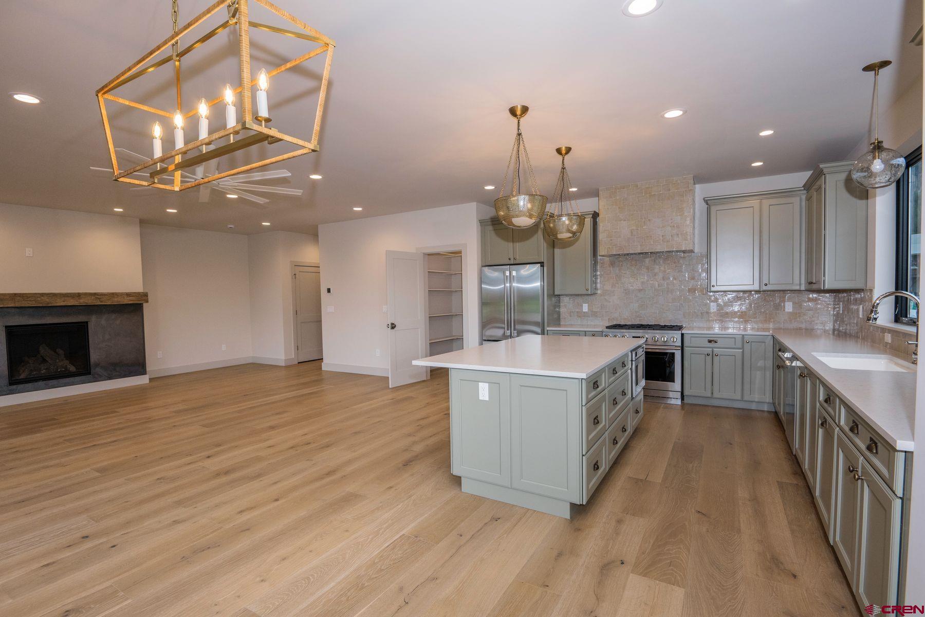 180 Elk Valley Road, Unit 107 Crested Butte, CO 81224 - Photo 5 of 35 a kitchen with stainless steel appliances granite countertop a sink a stove and a wooden floors