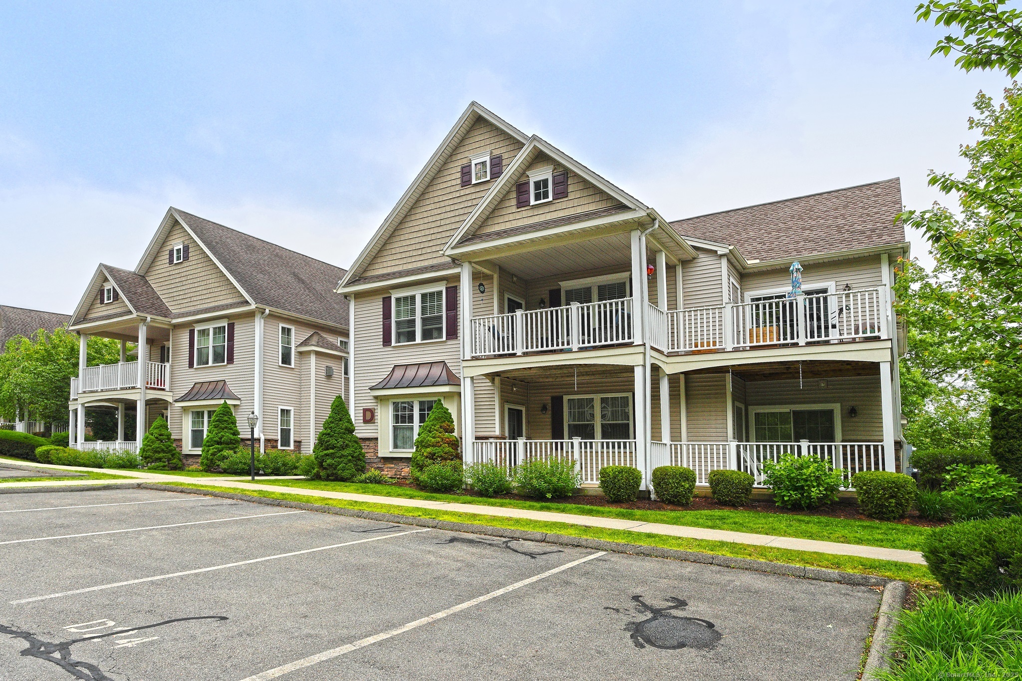 95 South Ridge Lane, Unit D201 Berlin, CT 06037 - Photo 1 of 1 a front view of a residential apartment building with a yard