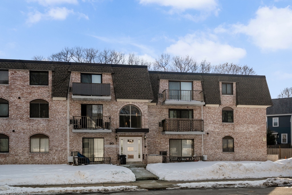 90 High Street, Unit 309 Dedham, MA 02026 - Photo 1 of 20 a view of multiple houses with a street