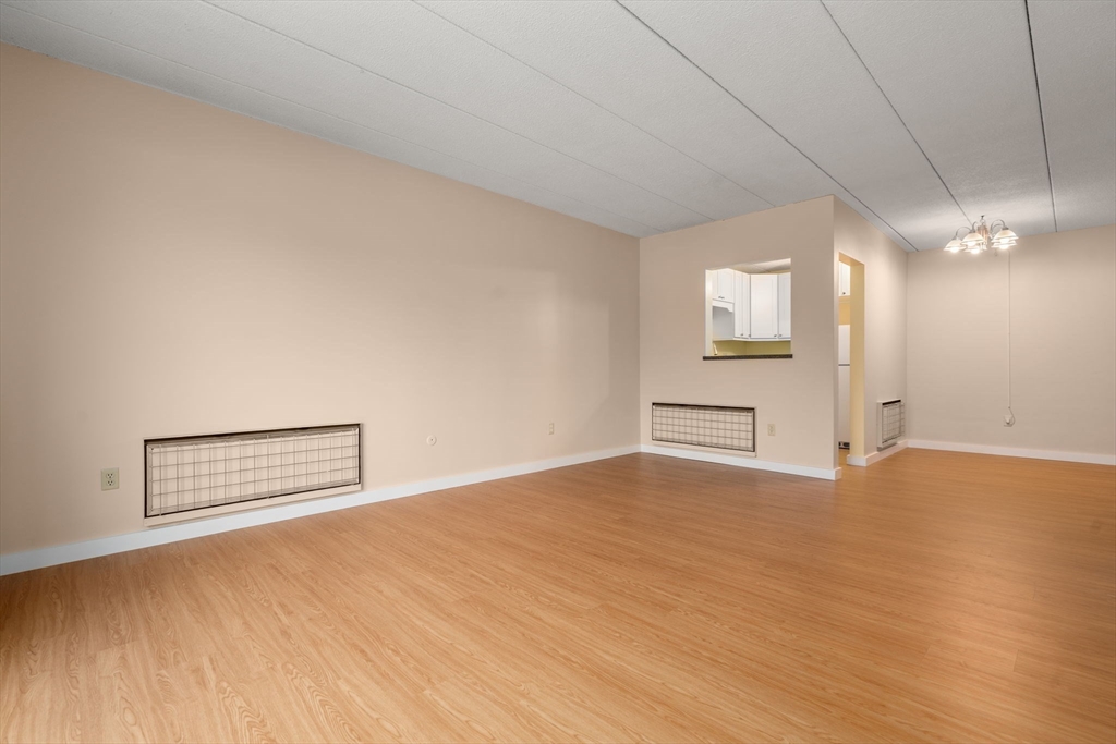 90 High Street, Unit 309 Dedham, MA 02026 - Photo 11 of 20 a view of empty room with wooden floor