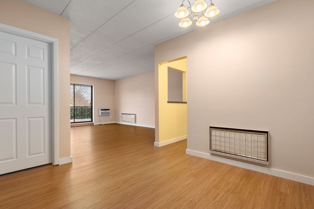 90 High Street, Unit 309 Dedham, MA 02026 - Photo 2 of 20 a view of empty room with wooden floor