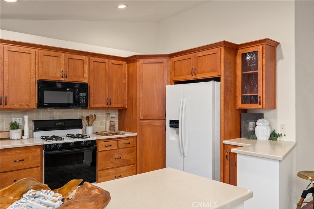 3 Cardiff Court Chico, CA 95973 - Photo 15 of 25 a kitchen with stainless steel appliances granite countertop a refrigerator stove top oven a sink and dishwasher