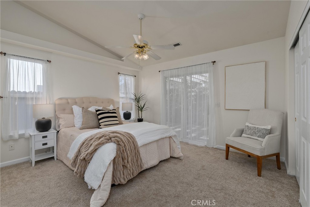 3 Cardiff Court Chico, CA 95973 - Photo 18 of 25 a spacious bedroom with a bed and a chandelier