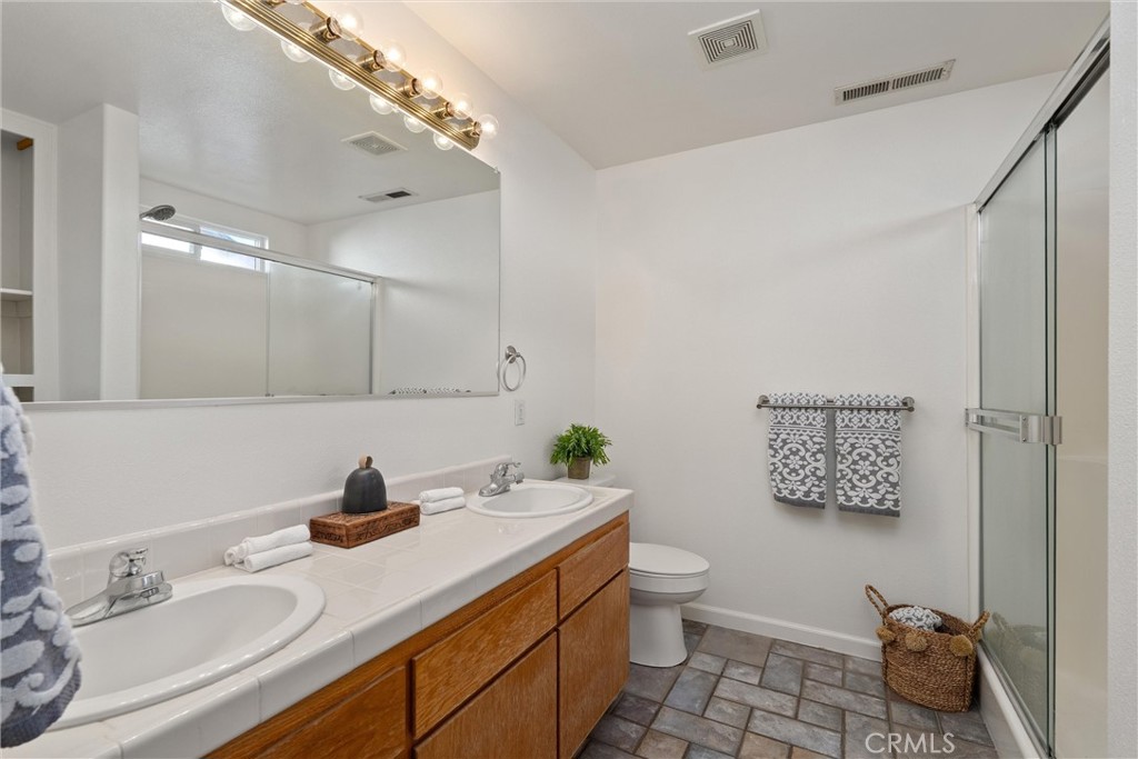 3 Cardiff Court Chico, CA 95973 - Photo 20 of 25 a bathroom with a sink double vanity and a toilet