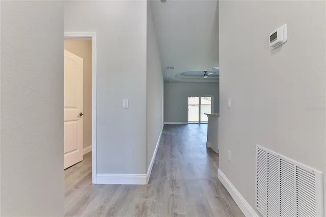 a view of a hallway with wooden floor