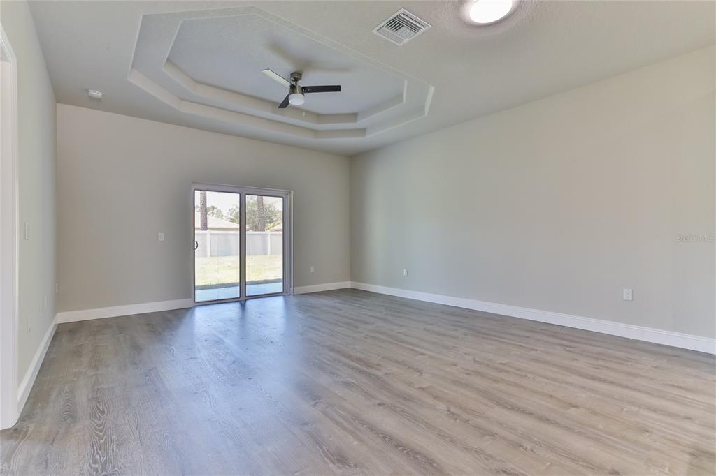 44 Easterly Place, Unit B Palm Coast, FL 32164 - Photo 7 of 21 a view of an empty room with wooden floor and a window