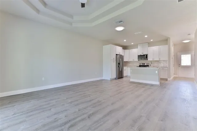 a view of a kitchen with a sink and a refrigerator