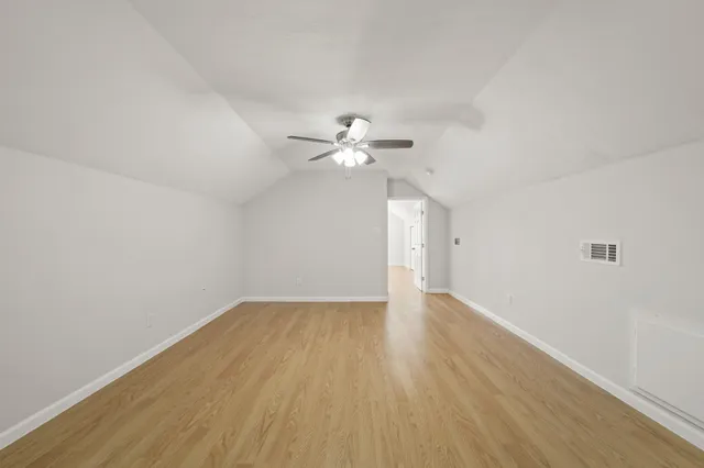 a view of a kitchen with a sink and a refrigerator