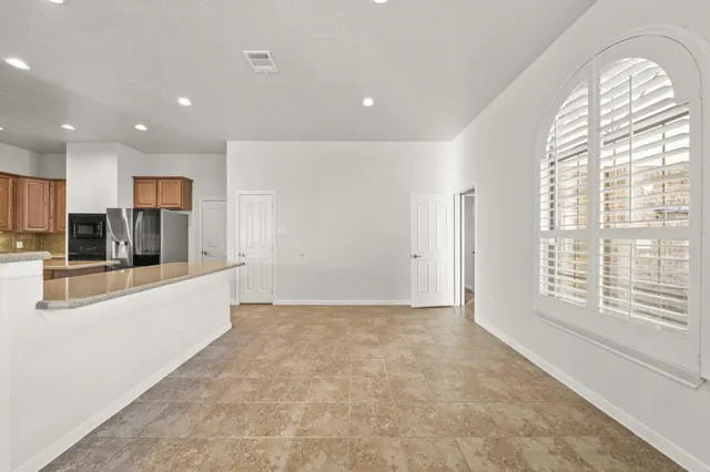 a view of a kitchen with a sink and a large window