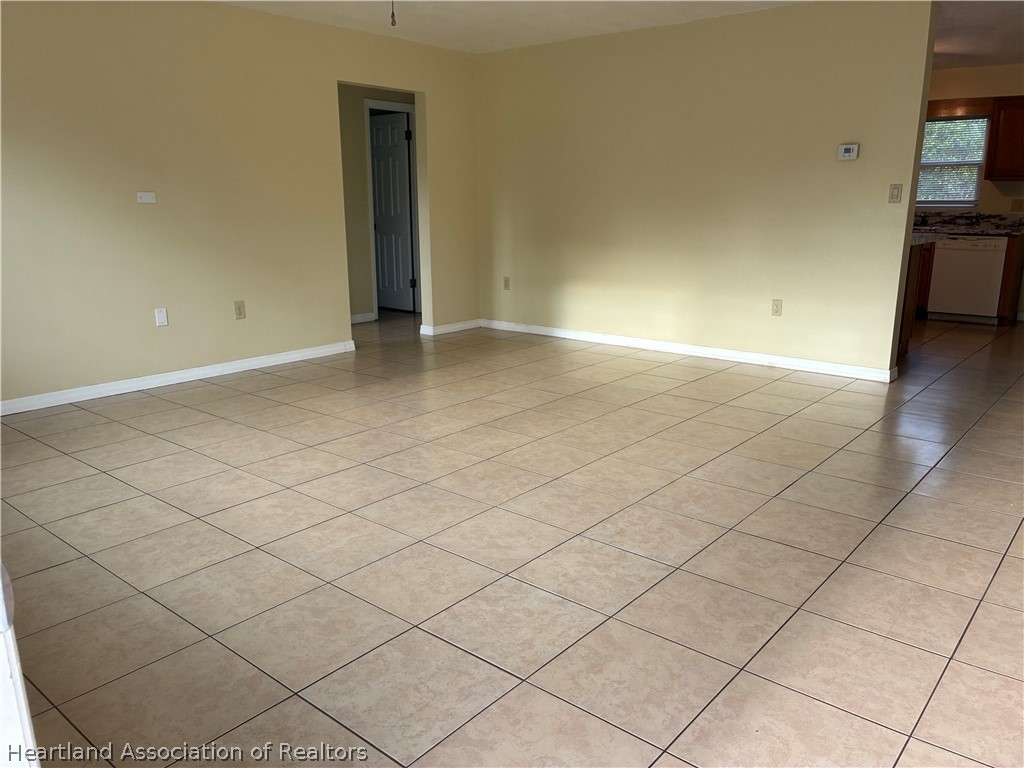 1525 Lagrange Avenue Sebring, FL 33870 - Photo 2 of 16 an empty room with a fireplace