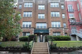1447 Chapin Street Northwest, Unit 204 Washington, DC 20009 - Photo 2 of 4 a front view of a residential apartment building with a yard