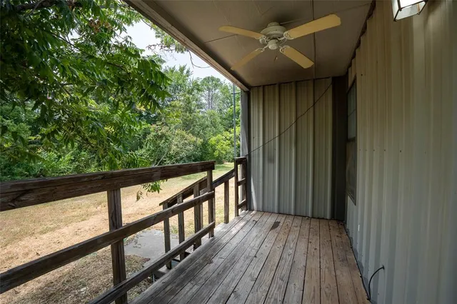 a view of a balcony with wooden floor