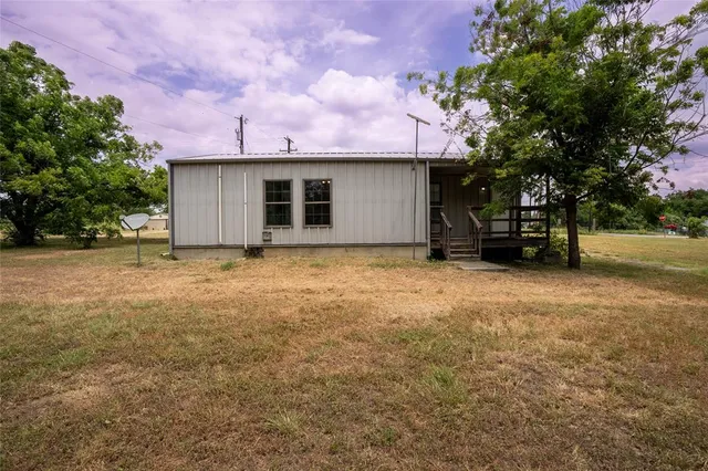 a view of a house with a yard and garage