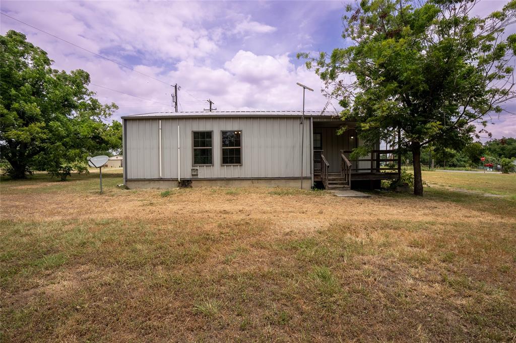 909 Fox Lane Azle, TX 76020 - Photo 13 of 13 a view of a house with a yard and garage