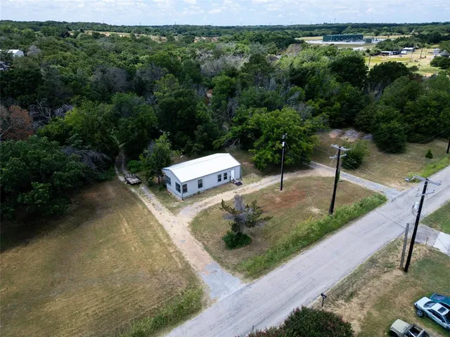 an aerial view of a house with a yard