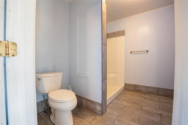 a bathroom with a toilet and a shower