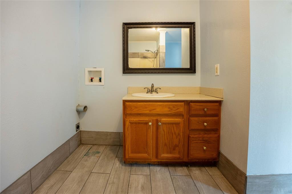 909 Fox Lane Azle, TX 76020 - Photo 9 of 13 a bathroom with a sink and a mirror