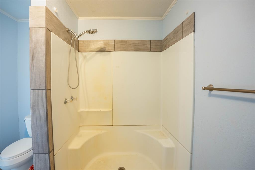 909 Fox Lane Azle, TX 76020 - Photo 10 of 13 a bathroom that has a glass shower door