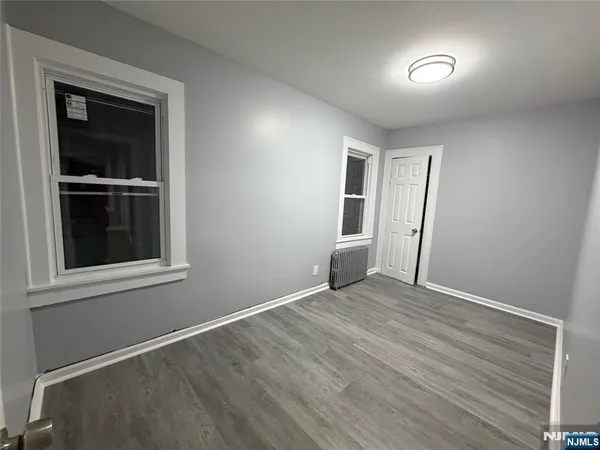 an empty room with windows and closet