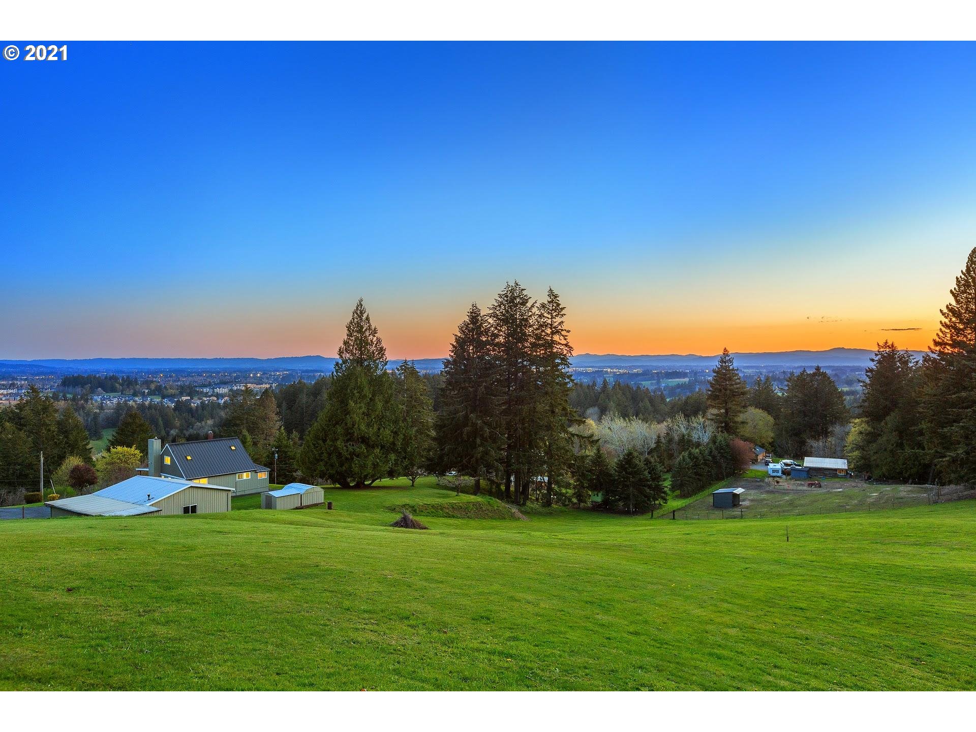 14345 Northwest Germantown Road Portland, OR 97231 - Photo 9 of 10 a view of a grassy field with trees in the background