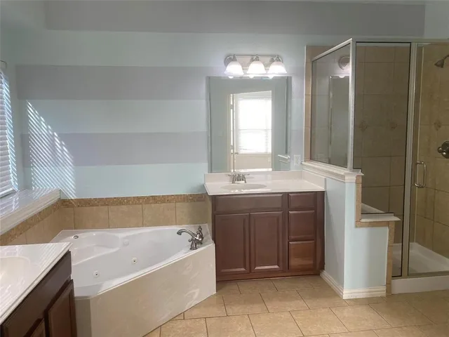 a bathroom with a shower and a sink