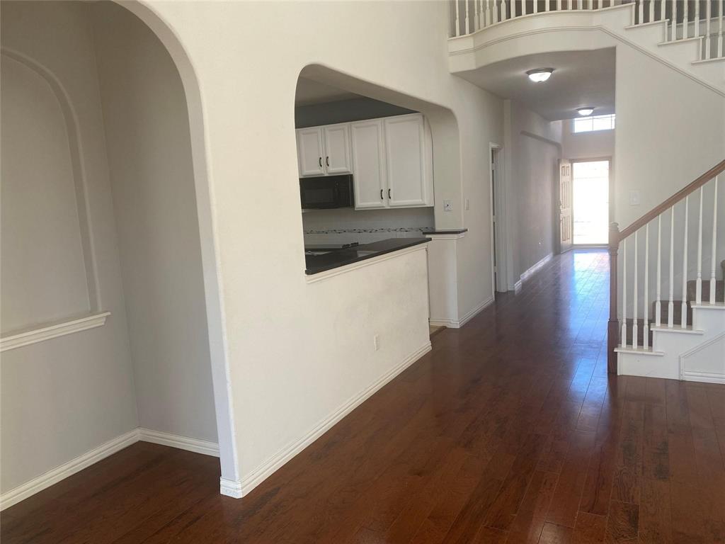 612 Catalpa Road Fort Worth, TX 76131 - Photo 3 of 26 a kitchen with a refrigerator and a stove top oven