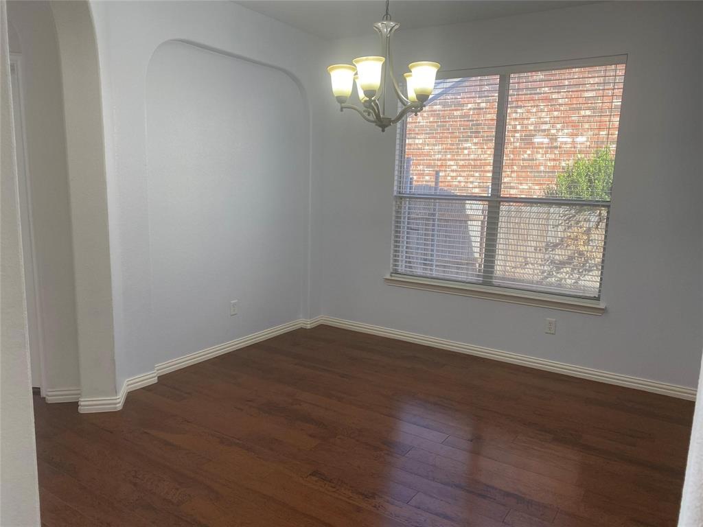612 Catalpa Road Fort Worth, TX 76131 - Photo 5 of 26 a view of an empty room with wooden floor and a window