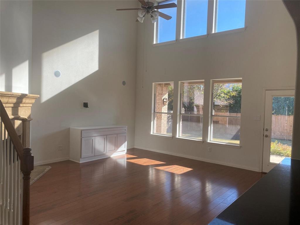 612 Catalpa Road Fort Worth, TX 76131 - Photo 7 of 26 a view of an empty room with a window and wooden floor