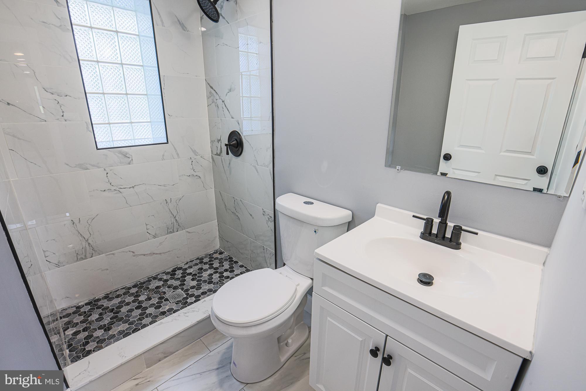 3715 Washington Avenue Baltimore, MD 21244 - Photo 32 of 57 a bathroom with a sink toilet and shower