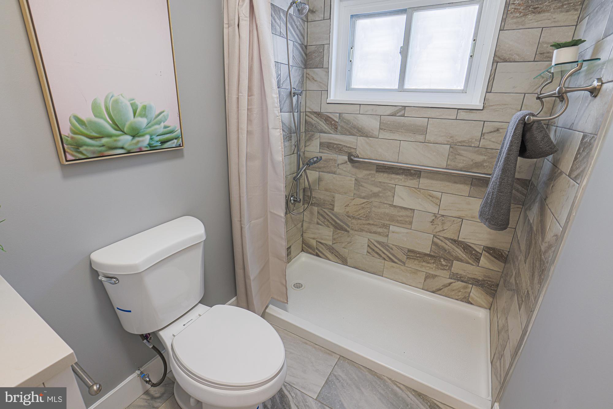 3715 Washington Avenue Baltimore, MD 21244 - Photo 42 of 57 a white toilet sitting next to a bath tub