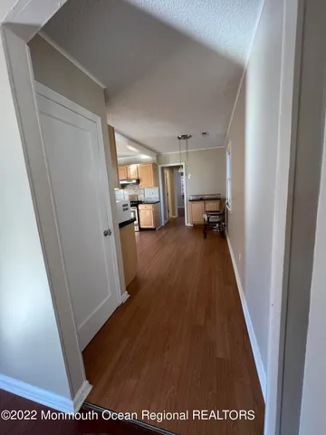 a view of a hallway to a livingroom and a couch