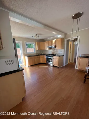 a living room filled with furniture and a wooden floor